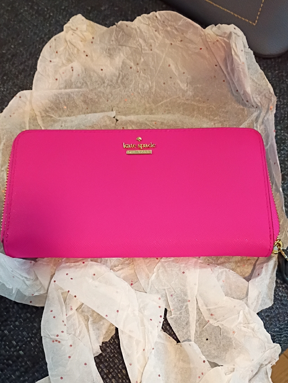 Kate Spade  hot pink zip-around wallet with gold logo